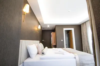 a hotel room with two beds and a ceiling at KAR BEYAZ HOTEL BURSA in Bursa
