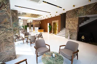 a lobby of a hotel with chairs and a fireplace at KAR BEYAZ HOTEL BURSA in Bursa
