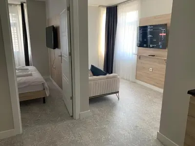 a living room with a couch and a tv in a room at Taksim Galatist Hotel in Istanbul