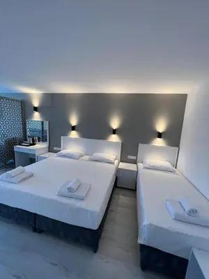 two beds in a room with white walls at Hotel Peninsula in Istanbul