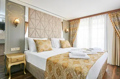a hotel room with a large bed with towels on it at Sultan Suleyman Palace Hotel & Spa in Istanbul