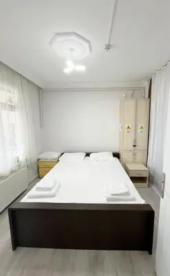 a bedroom with a large bed with white sheets at Sapanca Albar Konaklama in Sapanca
