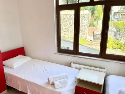 a small bedroom with two beds and a window at Sapanca Albar Konaklama in Sapanca