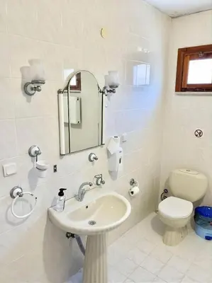 a bathroom with a sink and a toilet and a mirror at Sapanca Albar Konaklama in Sapanca