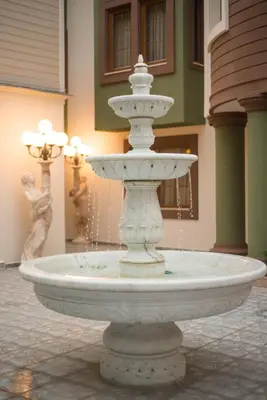 a white fountain in the middle of a building at Cesmeli Konak Hotel Silivri in Silivri
