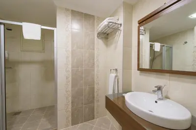 a bathroom with a sink and a shower at Cesmeli Konak Hotel Silivri in Silivri