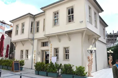 a building with two statues in front of it at Cesmeli Konak Hotel Silivri in Silivri