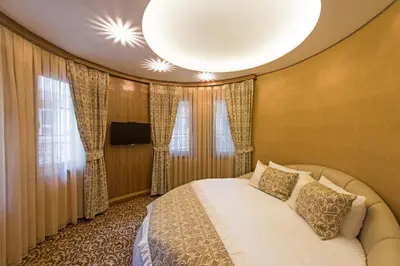 a bedroom with a bed and a large window at Cesmeli Konak Hotel Silivri in Silivri