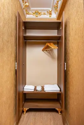 a closet with a wooden door with folded towels at The Ottoman in Istanbul