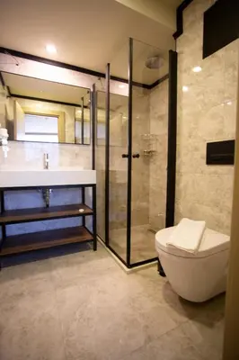 a bathroom with a shower and a toilet and a sink at Beşiktaş Serenity Hotel in Istanbul