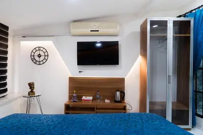 a bedroom with a bed and a tv on the wall at The Havana Residence in Istanbul