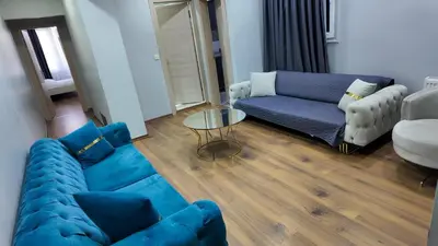 a living room with a blue couch and a table at Sisli House By Remar Holding in Istanbul
