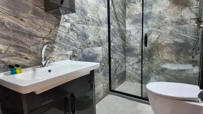 a bathroom with a sink and a shower at Sisli House By Remar Holding in Istanbul