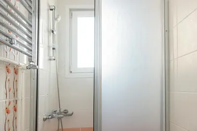 a shower with a glass door in a bathroom at Dualis Hotel in Istanbul