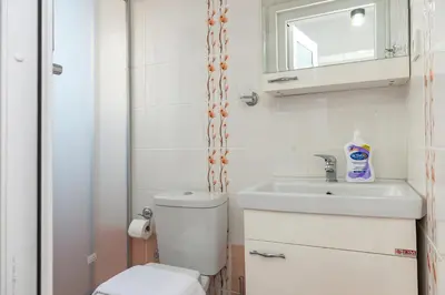 a bathroom with a toilet and a sink and a mirror at Dualis Hotel in Istanbul