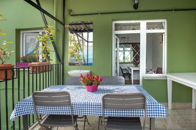 a table with a blue and white checkered table cloth on a balcony at Dualis Hotel in Istanbul
