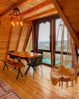 a dining room with a hammock and a table and chairs at Dorabungalov in Sakarya