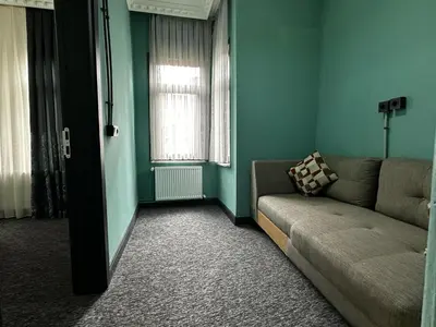 a living room with a couch and a window at SEVEN ROSES APART HOTEL in Istanbul
