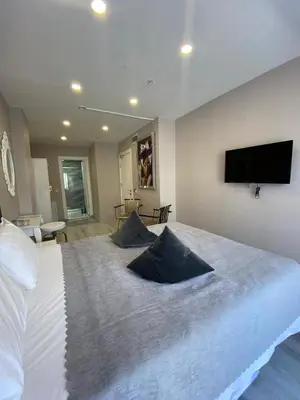a bedroom with a large bed with a flat screen tv on the wall at ATİK HOTEL in Istanbul