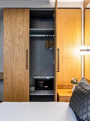 a bedroom with a bed and wooden cabinets at Endican Sultanahmet Hotel in Istanbul