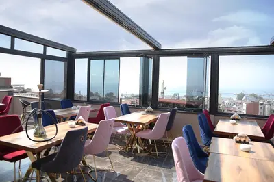 a restaurant with tables and chairs and large windows at The Grand Tower Hotel in Istanbul