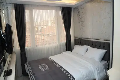 a small bedroom with a bed and a window at The Grand Tower Hotel in Istanbul