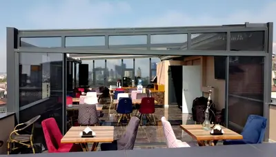 a balcony with tables and chairs on a building at The Grand Tower Hotel in Istanbul