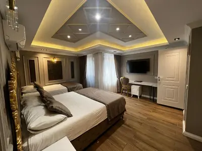 a bedroom with a large bed and a desk at Violette Mansion Oldcity in Istanbul
