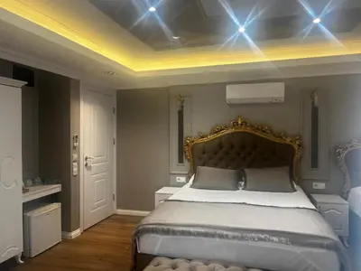 a bedroom with a large bed with a gold headboard at Violette Mansion Oldcity in Istanbul