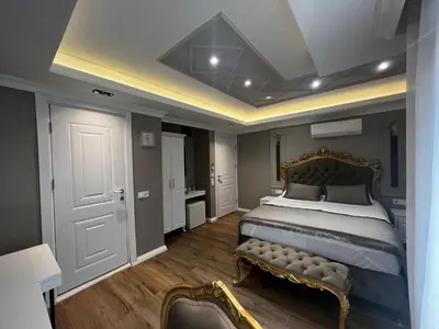 a bedroom with a bed with a bench in it at Violette Mansion Oldcity in Istanbul