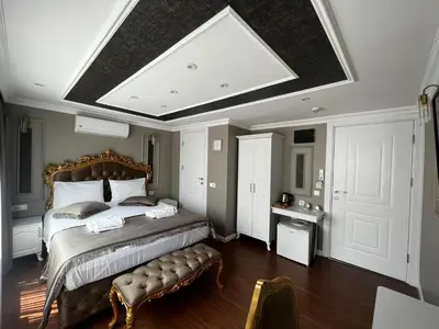 a bedroom with a large bed with a bench in it at Violette Mansion Oldcity in Istanbul