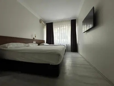 a bedroom with two beds and a window at Altinnal Hotel in Kocaeli