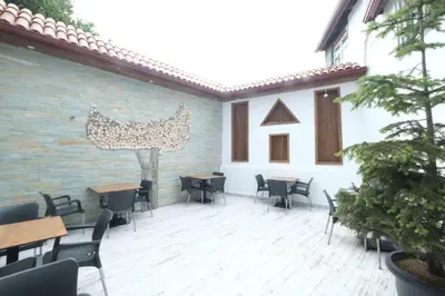 a patio with tables and chairs in a building at Victorious Hotel in Istanbul