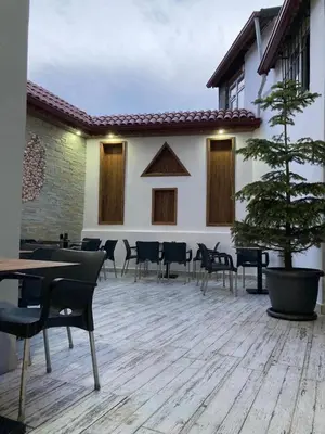 a patio with a table and chairs and a tree at Victorious Hotel in Istanbul