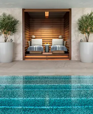 a pool in front of a hotel with two beds at Address Istanbul in Istanbul