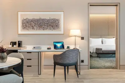 a hotel room with a desk and a bed at Address Istanbul in Istanbul