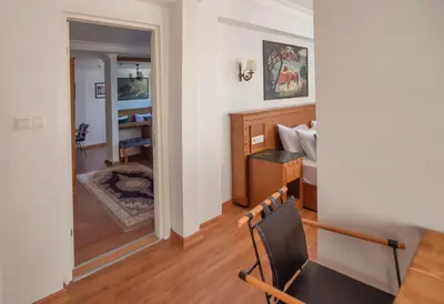 a room with a desk and a bed and a dining room at Duru Sultanahmet Apart & Suites in Istanbul