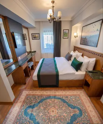a hotel room with a bed and a desk at Duru Sultanahmet Apart & Suites in Istanbul