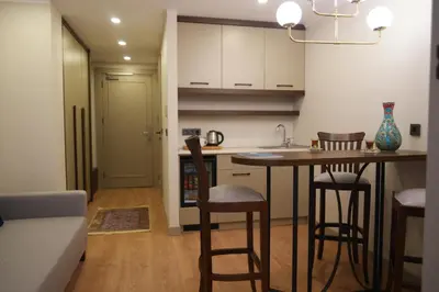 a kitchen with a table and chairs in a room at Nevi Hotel & Suites Istanbul Taksim in Istanbul