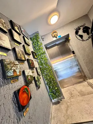 a kitchen with a refrigerator with a shelf filled with greens at Pera Pansiyon in Bursa