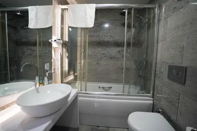 a bathroom with a sink and a toilet and a tub at Time Hotel Mecidiyekoy in Istanbul