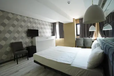 a hotel room with a bed and a tv at Time Hotel Mecidiyekoy in Istanbul