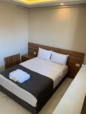 a bedroom with a bed with two towels on it at Royal Residence Bursa in Bursa