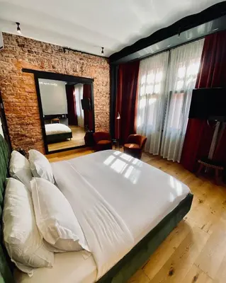 a bedroom with a large bed and a brick wall at RUZ Hotels in Istanbul