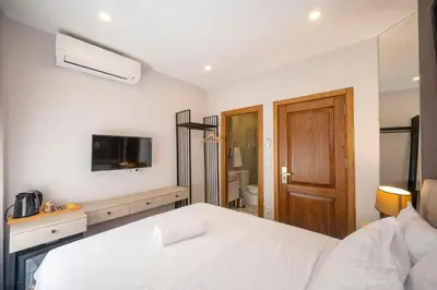 a bedroom with a white bed and a television at TAKSİM SUİTE in Istanbul