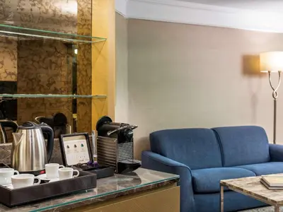 a living room with a blue couch and a table at Radisson Blu Hotel, Istanbul Sisli in Istanbul