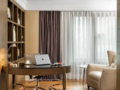 a living room with a table with a laptop on it at Radisson Blu Hotel, Istanbul Sisli in Istanbul