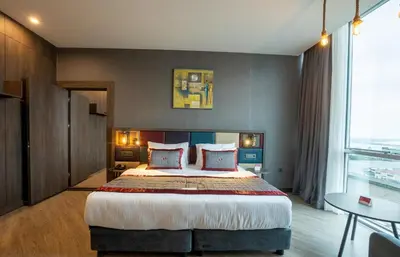 a bedroom with a large bed and a large window at Ramada Encore by Wyndham Istanbul Avcilar in Istanbul