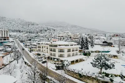 a city covered in snow with buildings at Motali Life Hotel in Masukiye