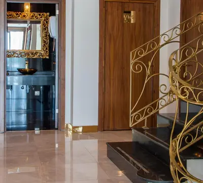 a hallway with a mirror and a staircase in a house at Motali Life Hotel in Masukiye